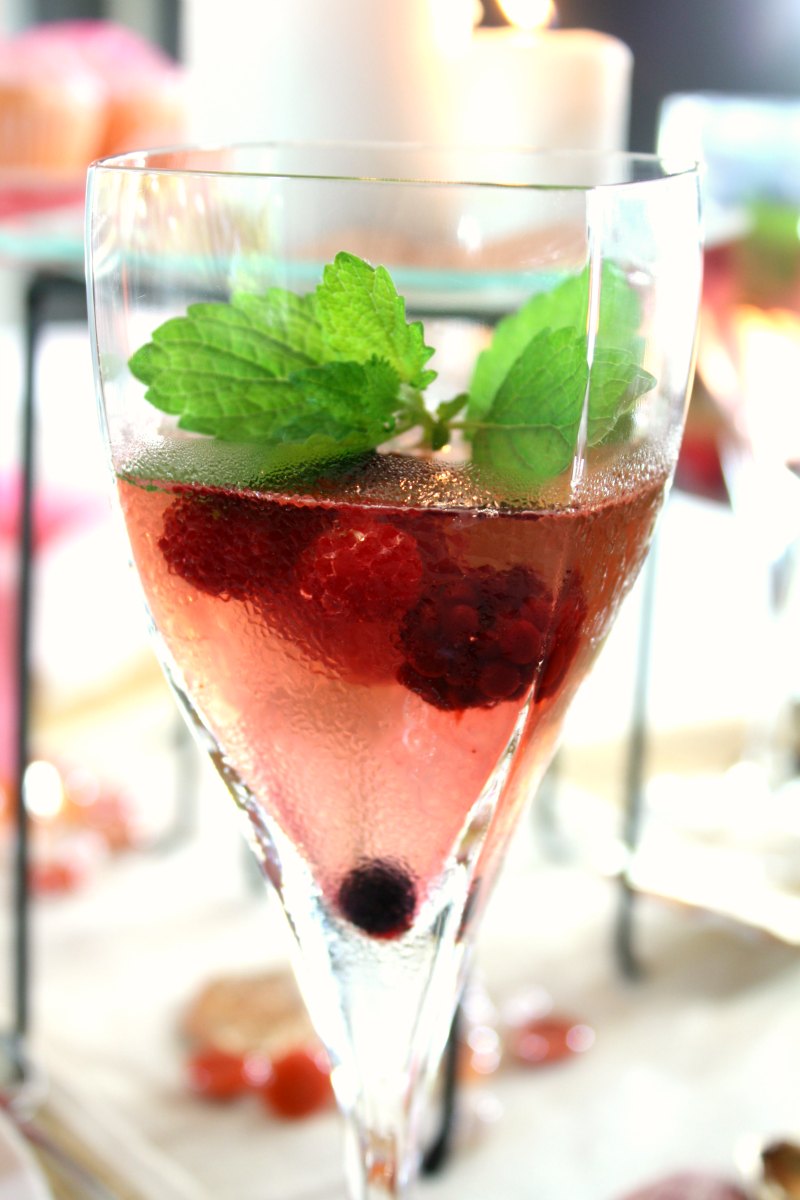 Mixed berry sangria garnished with lemon balm