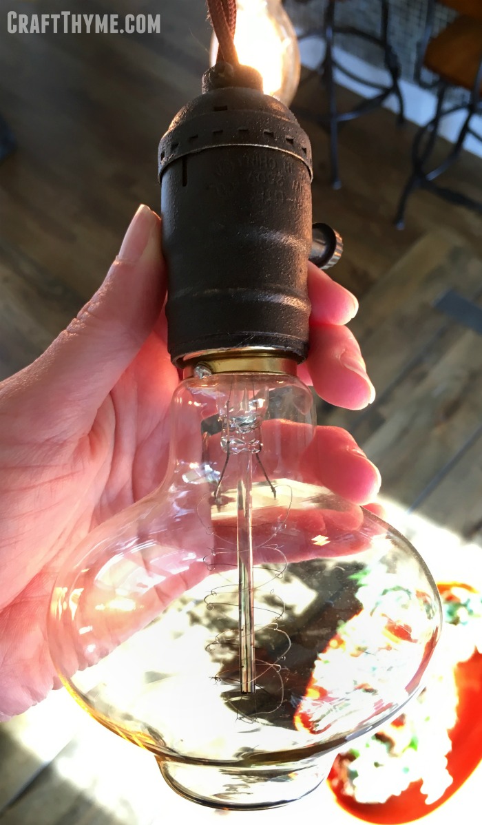 A flattened edison bulb makes a unique touch to a light fixture