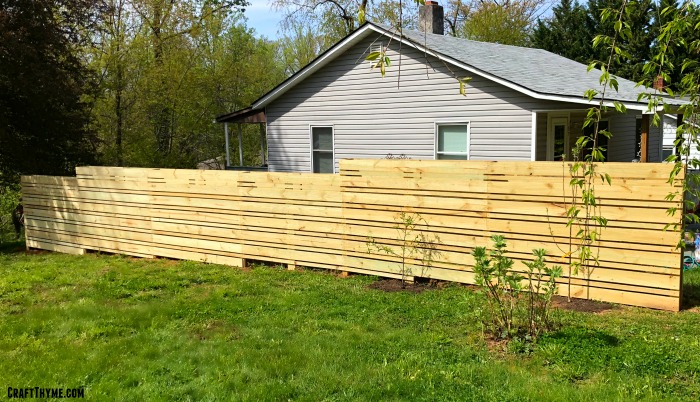 Wooden composting fence with espalier fruit trees